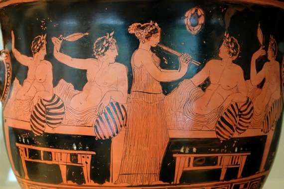 Αυλήτρια ψυχαγωγεί άνδρες σε συμπόσιο (420 π.Χ.)