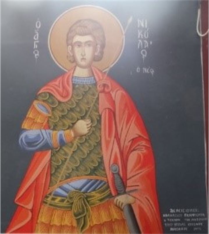 Εικόνα 4 Τοιχογραφία του 1993 στον Ι.Ν. Αγ. Θεοδώρων Καστανιάς Σερβίων. Εικονίζεται ο Άγιος Νικόλαος ο Νέος, ένα πρόσωπο στρατιωτικού Αγίου που αντιστοιχεί είτε στον Άγιο Νικόλαο τον εν Βουνένοις είτε στον Άγιο Νικόλαο των από στρατιωτών, αν και οι δύο Άγιοι φαίνεται να ήταν ταυτισμένη στην λαϊκή συνείδηση κατά το παρελθόν. Περισσότερες πληροφορίες: (Σταμκόπουλος, Οι Κώμες του Αλιάκμονα: Μέρος Β' - Ο Άγιος, τα ονόματα και τα φαντάσματα του ποταμιού, 2022)